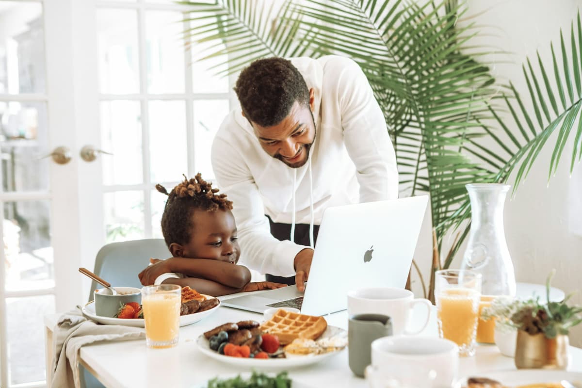 Father teaching his son- bout money while having breakfast together